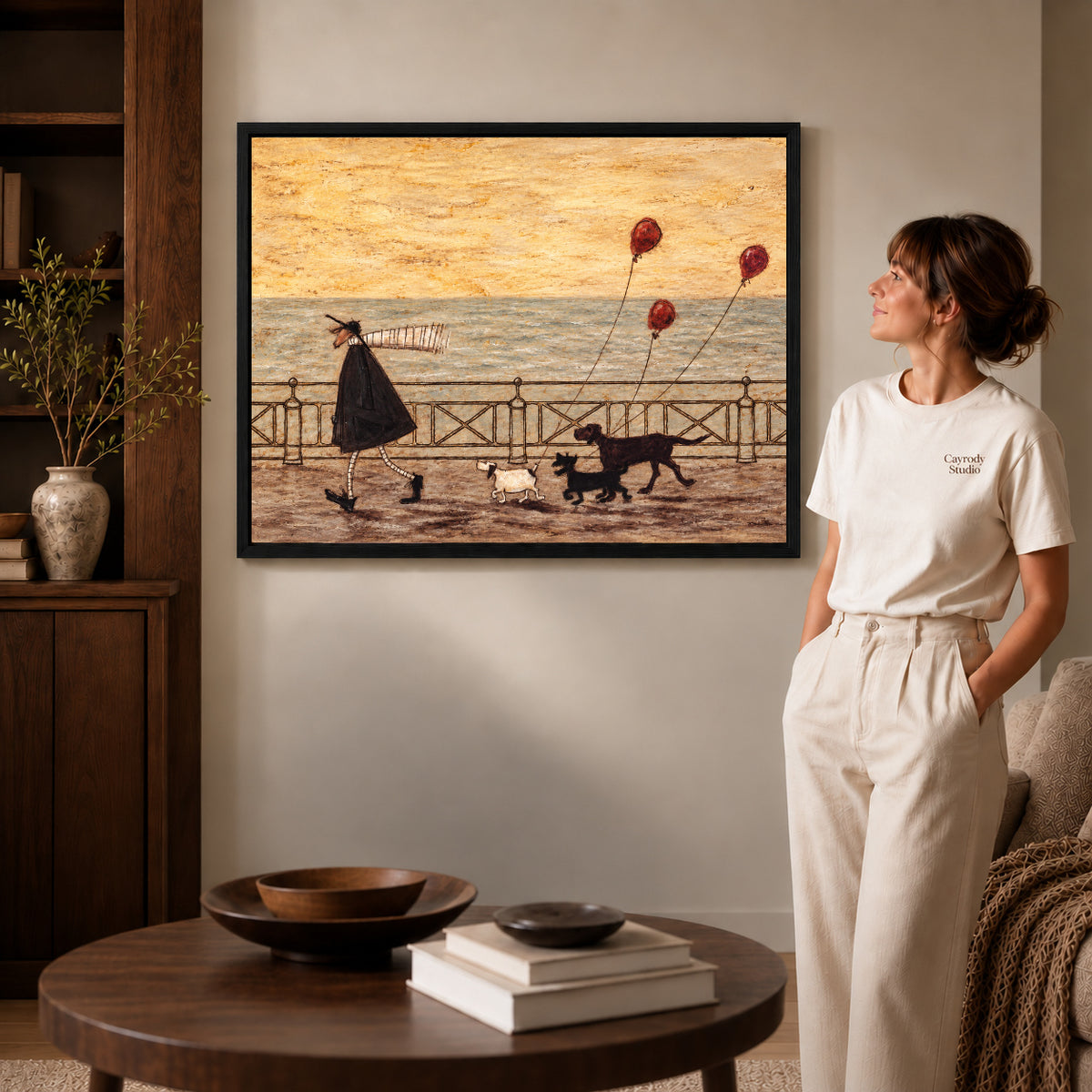 seaside dog walk canvas art shown in the black frame option against a softly lit wall.