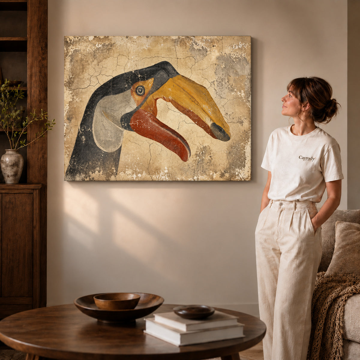 Gallery wrapped rustic toucan artwork with shaded canvas edges beside a woman wearing cream clothing.