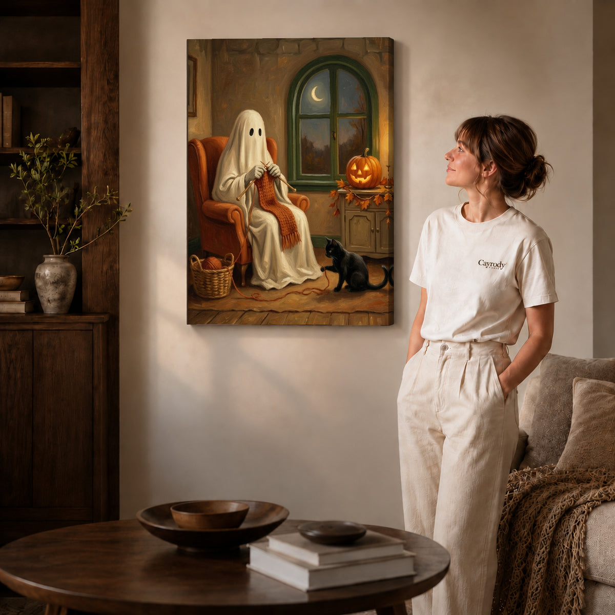 Gallery wrapped cozy knitting ghost canvas art with naturally shaded canvas edges beside a woman wearing cream clothing.