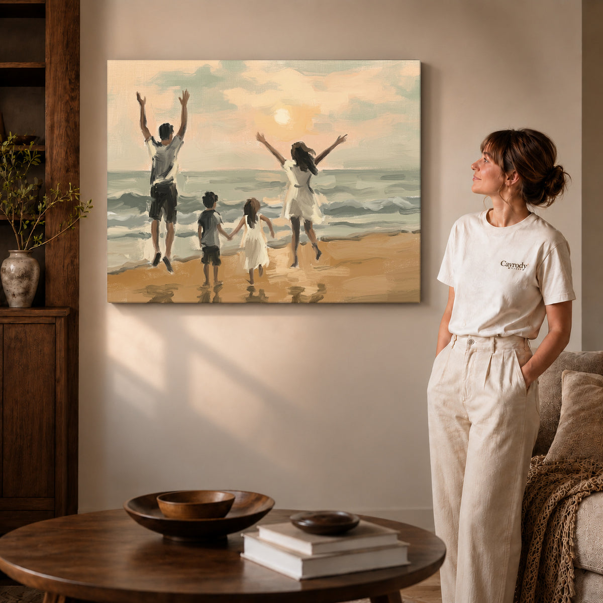 Gallery wrapped family beach sunset canvas art with naturally shaded canvas edges beside a woman wearing cream clothing.