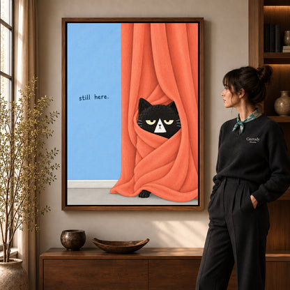 Curtain black cat canvas art in a walnut frame beside a standing woman in a warm living room.