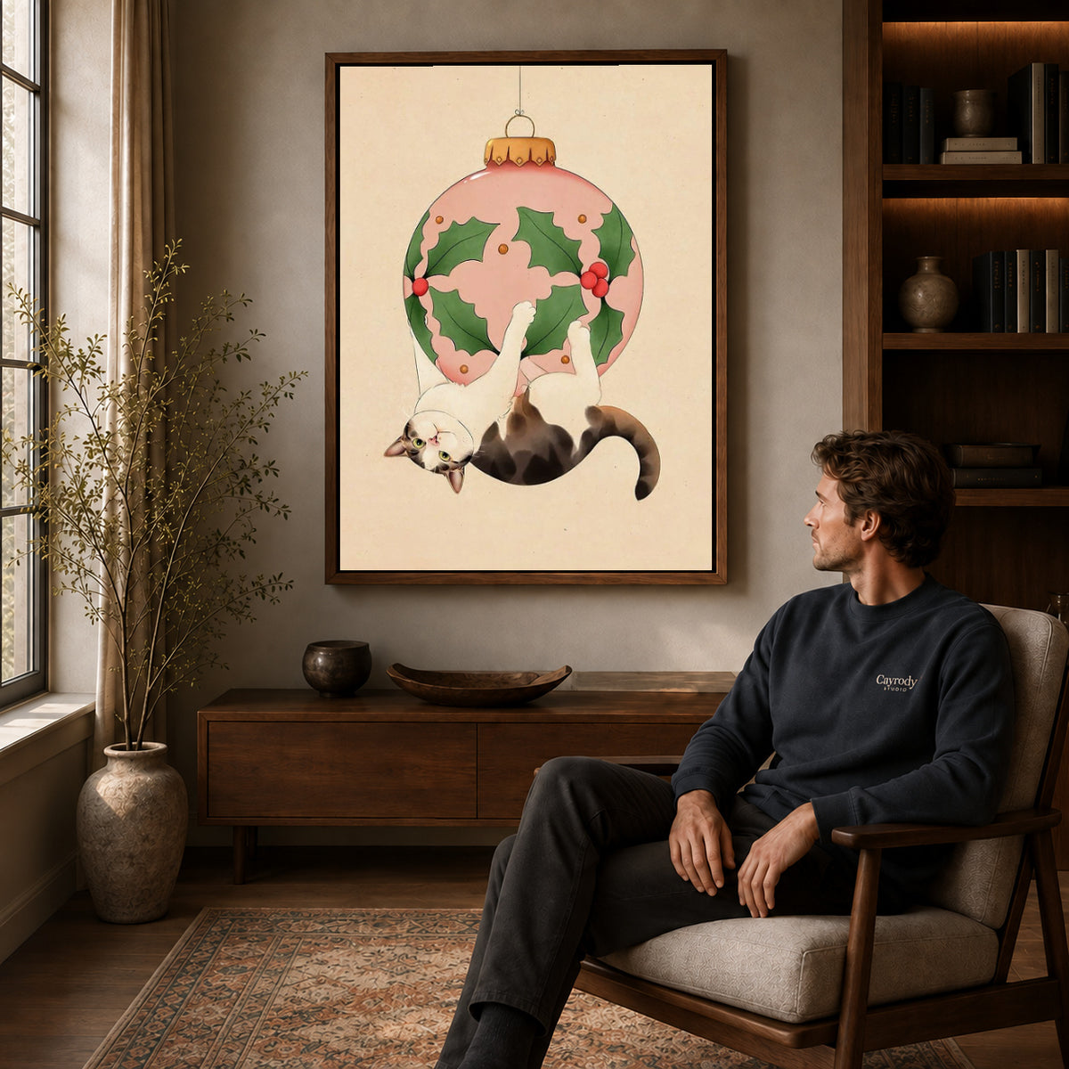 Walnut framed hanging holiday cat canvas art displayed above a seated man in a wood furnished room.