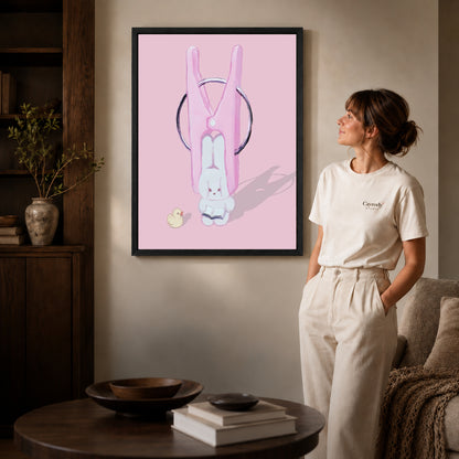 Black framed bunny clothespin canvas art displayed beside a woman in a warm neutral living room.