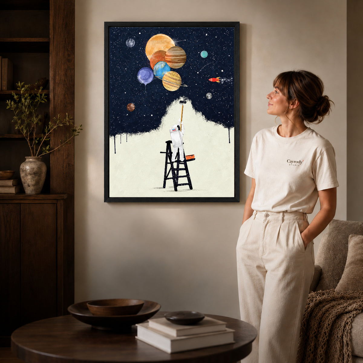Black framed astronaut painter canvas art room scene assigned to all six black framed canvas sizes.