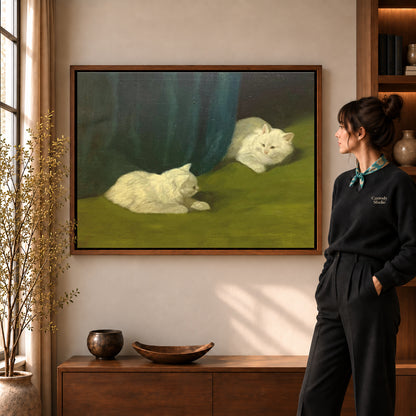 Quiet white cats canvas art in a walnut frame beside a standing woman in a warm living room.