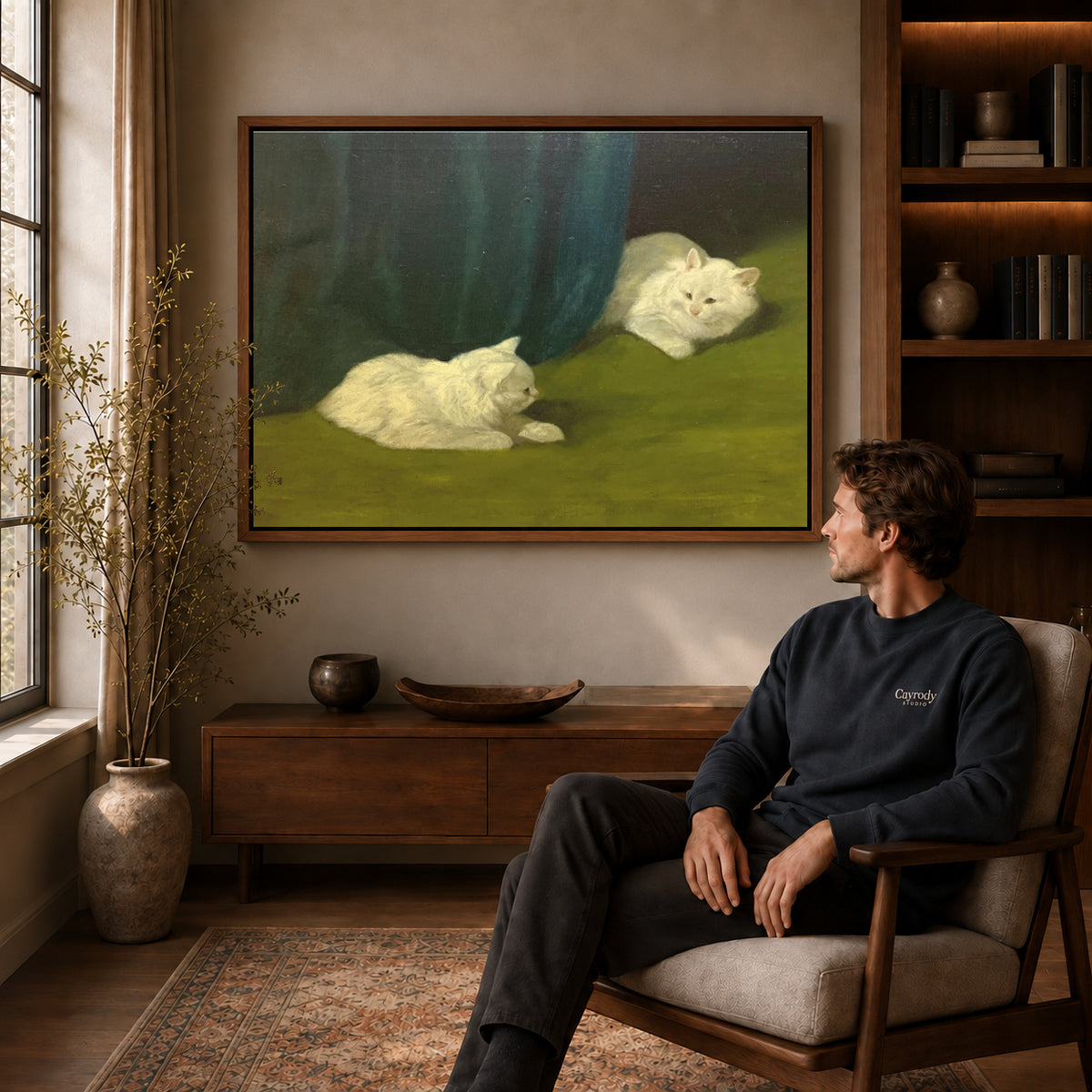 Walnut framed quiet white cats canvas art displayed above a seated man in a wood furnished room.