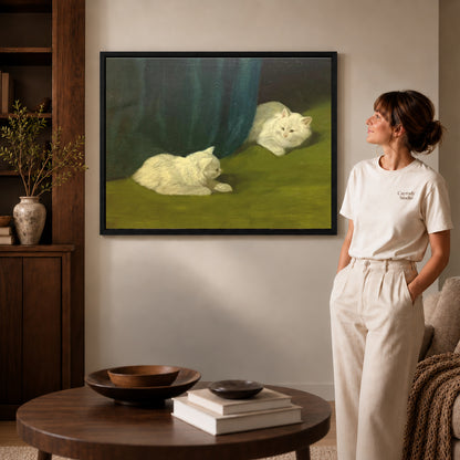 Black framed quiet white cats canvas art displayed beside a woman in a warm neutral living room.