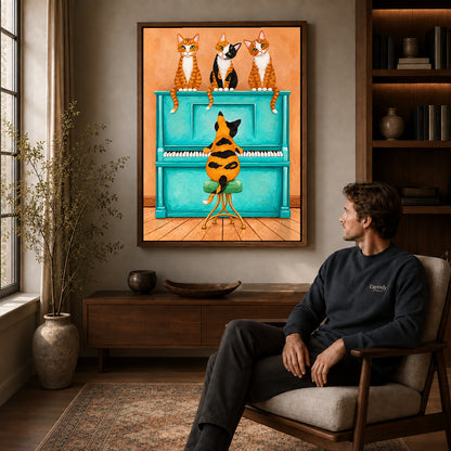 Walnut framed cat piano quartet canvas art displayed above a seated man in a wood furnished room.