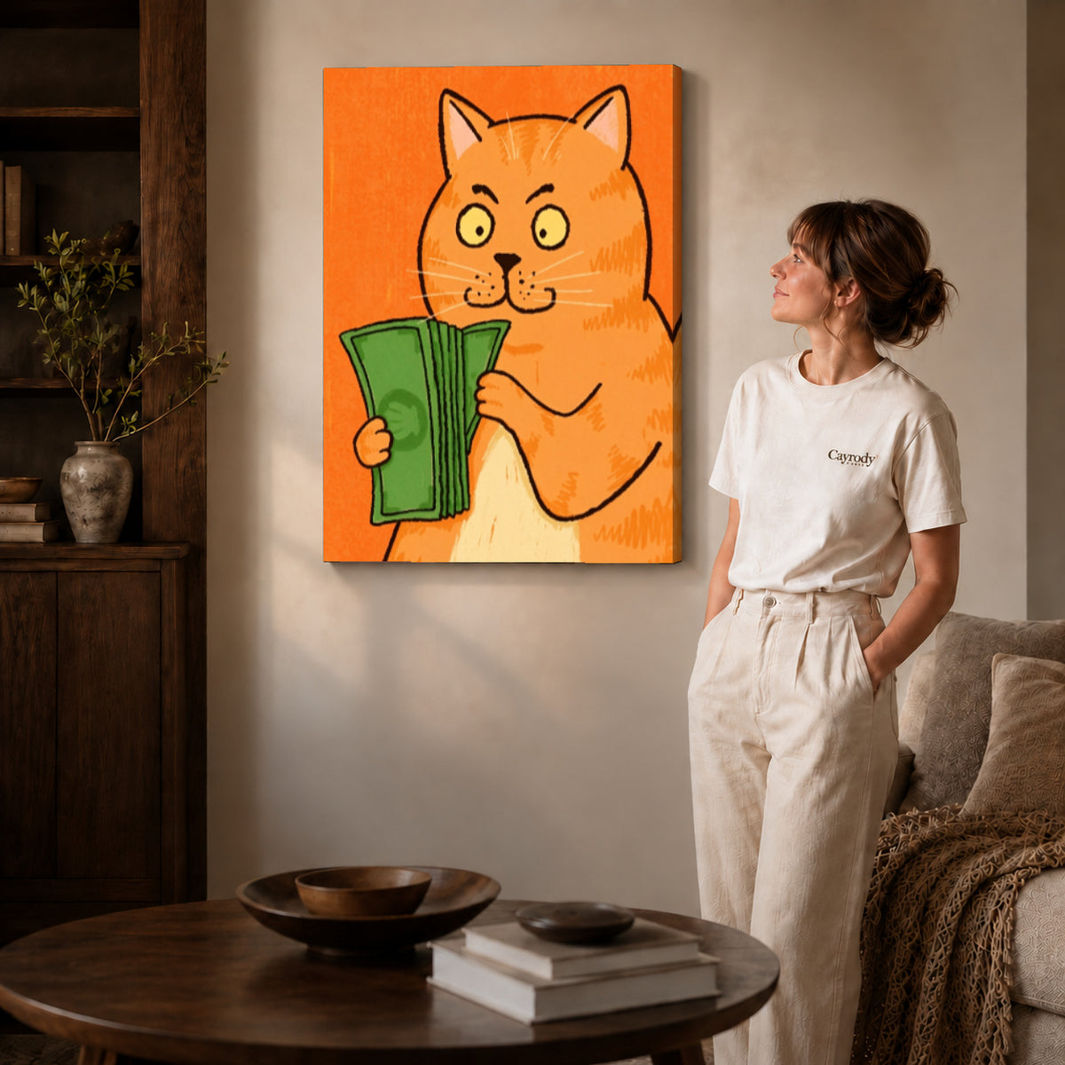 Gallery wrapped money cat portrait canvas art with naturally shaded canvas edges beside a woman wearing cream clothing.