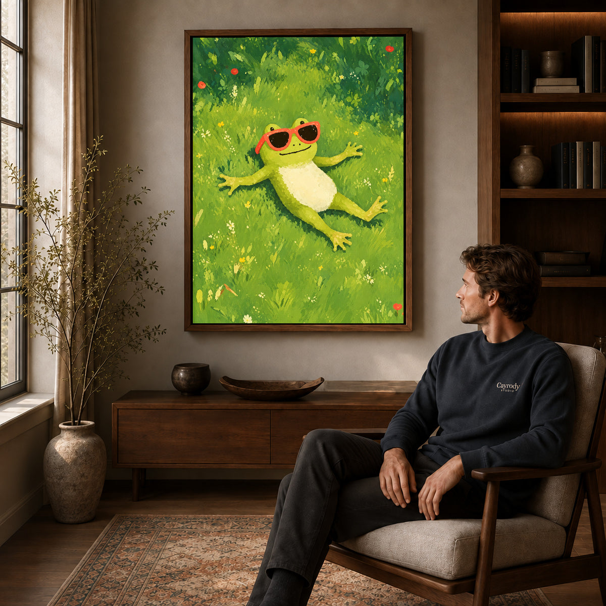 Walnut framed relaxed sunny frog canvas art displayed above a seated man in a wood furnished room.