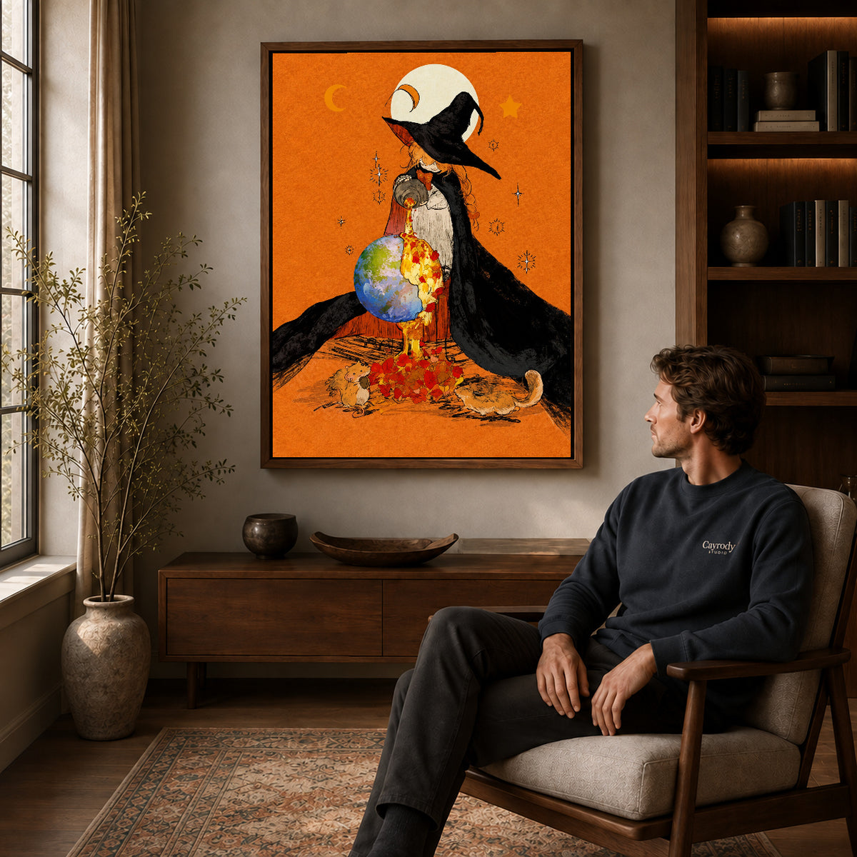 Walnut framed autumn globe witch artwork above a seated man in a wood furnished living room.