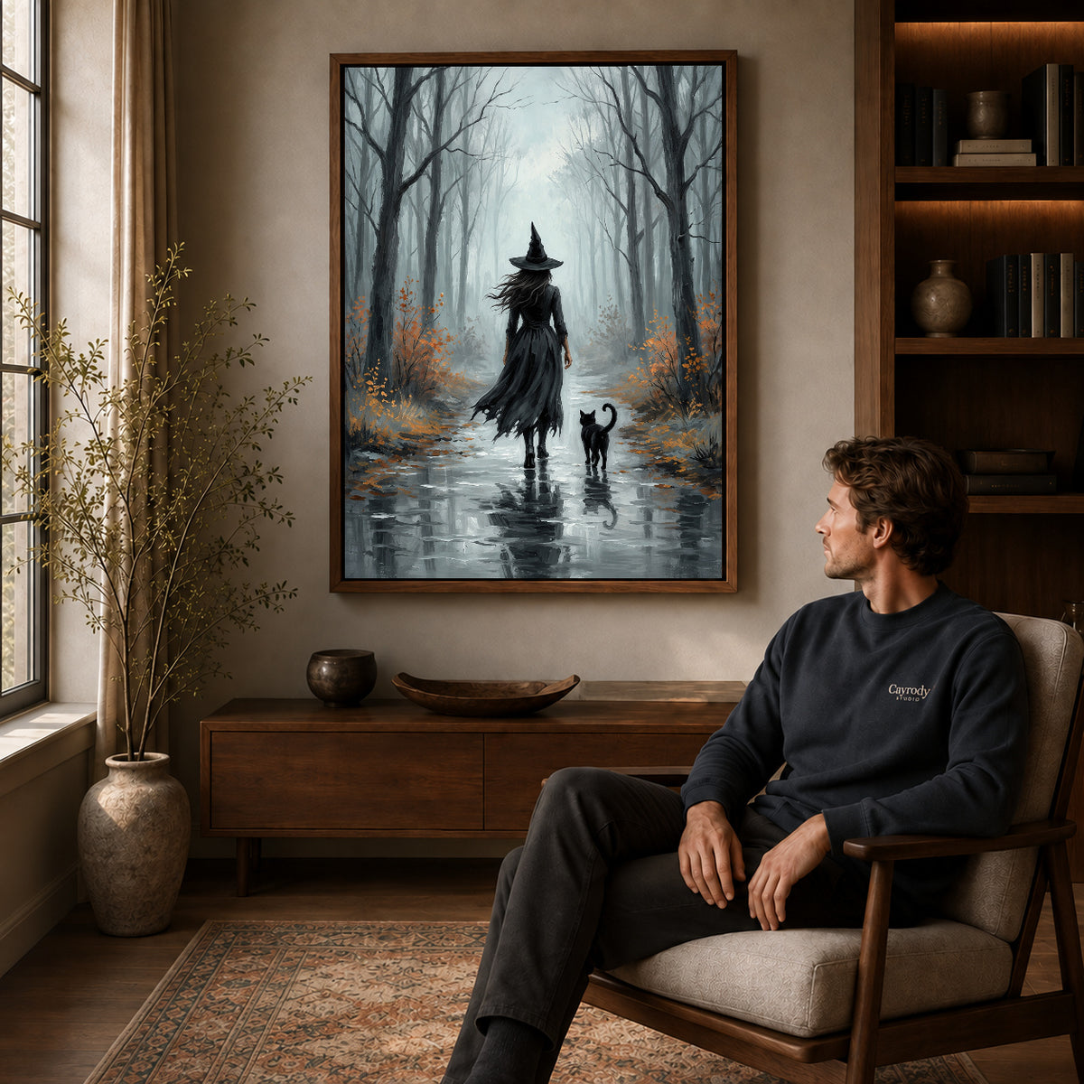 Walnut framed misty witch walk artwork above a seated man in a wood furnished living room.