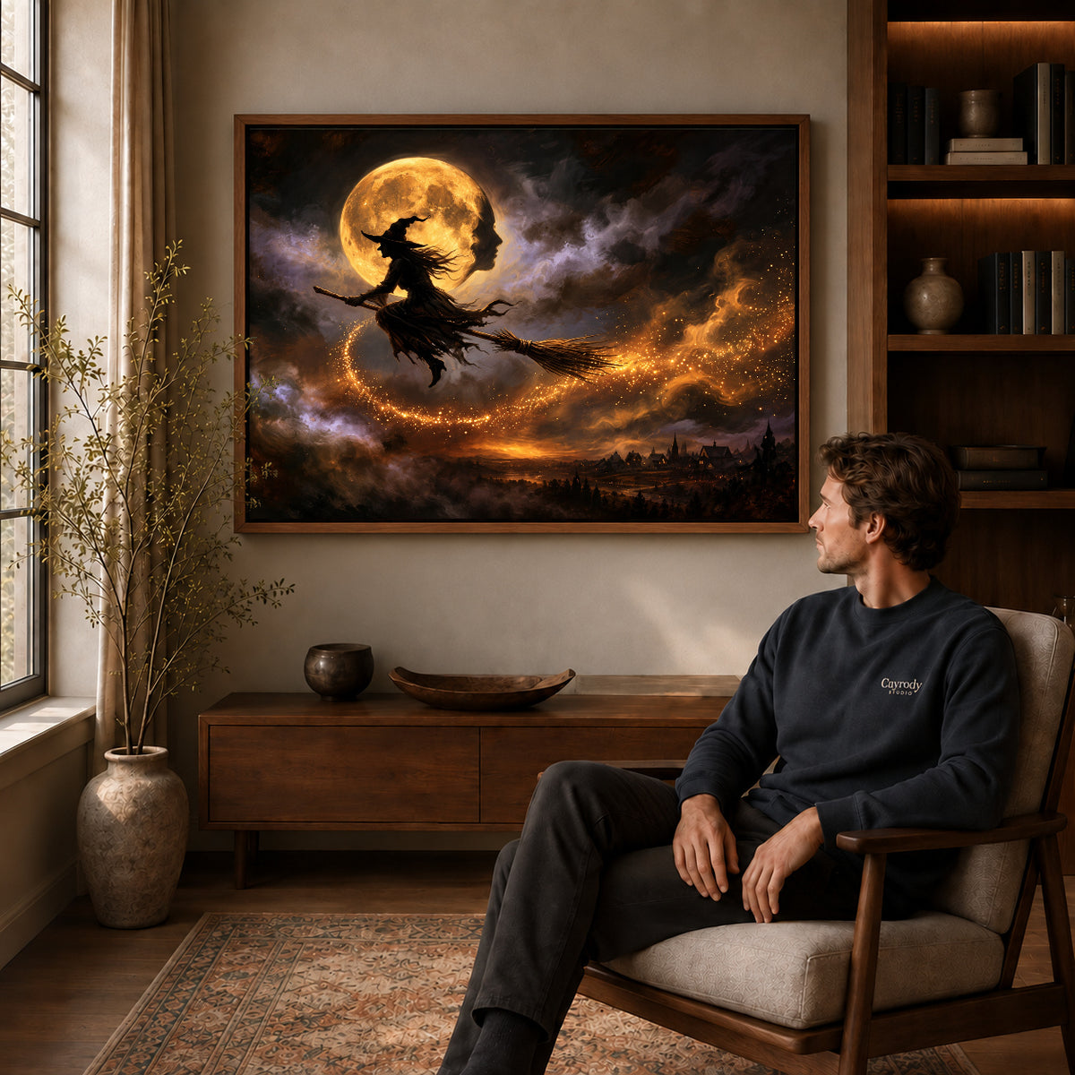 Walnut framed golden moon flight artwork above a seated man in a wood furnished living room.