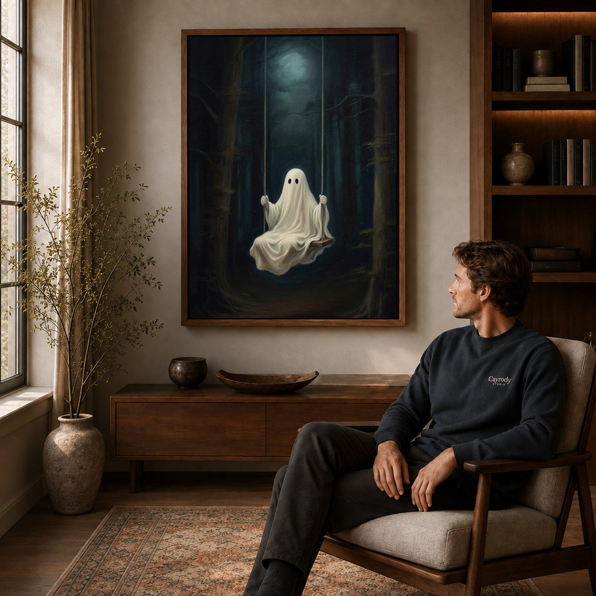 Walnut framed moonlit ghost swing canvas art displayed above a seated man in a wood furnished room.