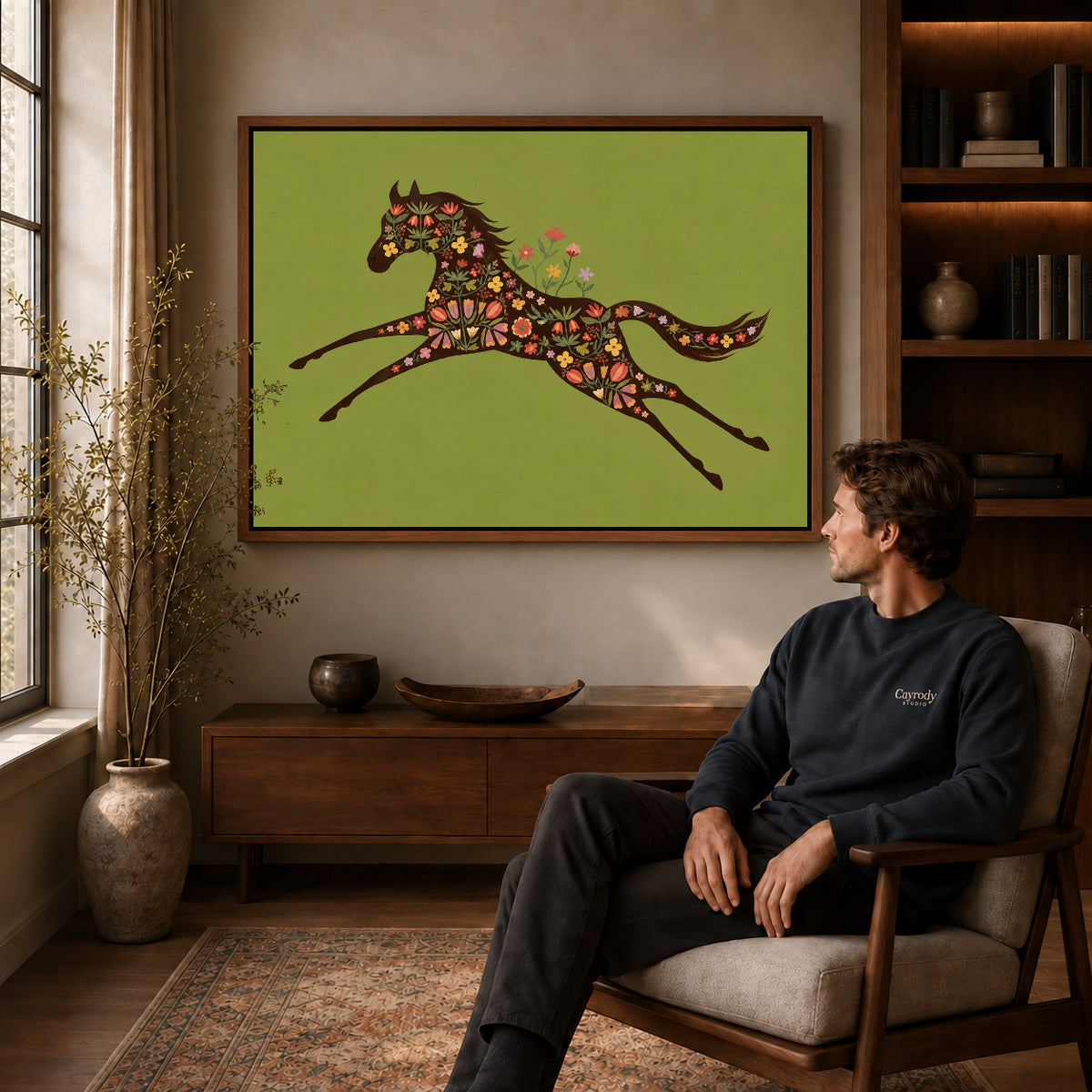 Walnut framed floral galloping horse artwork above a seated man in a wood furnished living room.