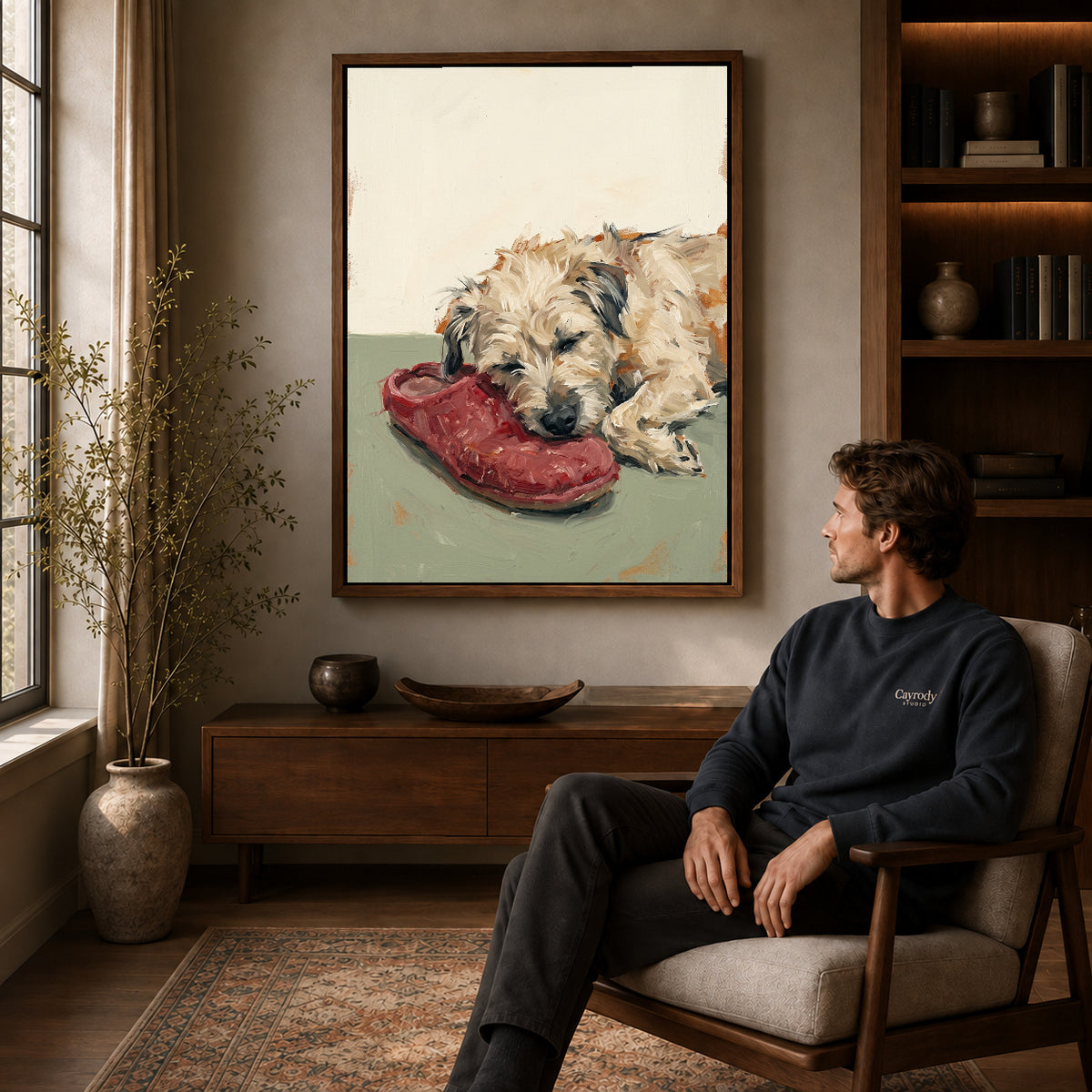 Walnut framed sleeping dog shoe canvas art displayed above a seated man in a wood furnished room.