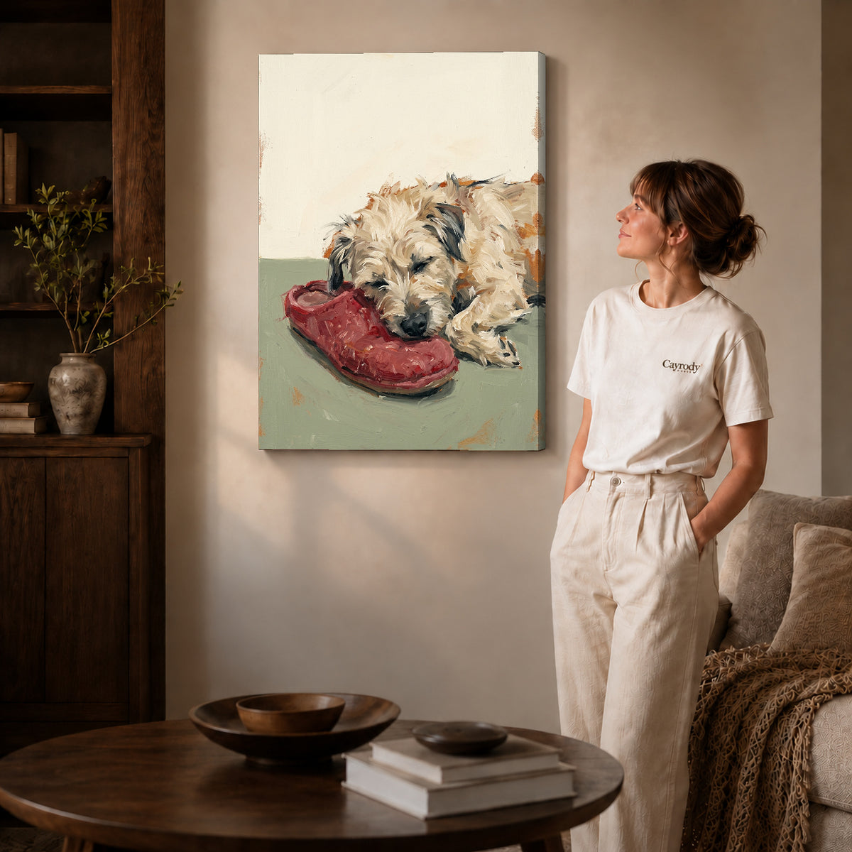 Gallery wrapped sleeping dog shoe canvas art with naturally shaded canvas edges beside a woman wearing cream clothing.