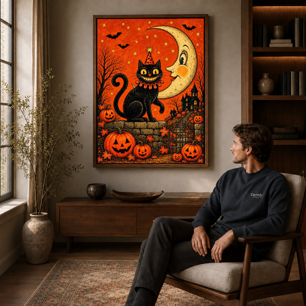 Walnut framed crescent halloween cat artwork above a seated man in a wood furnished living room.