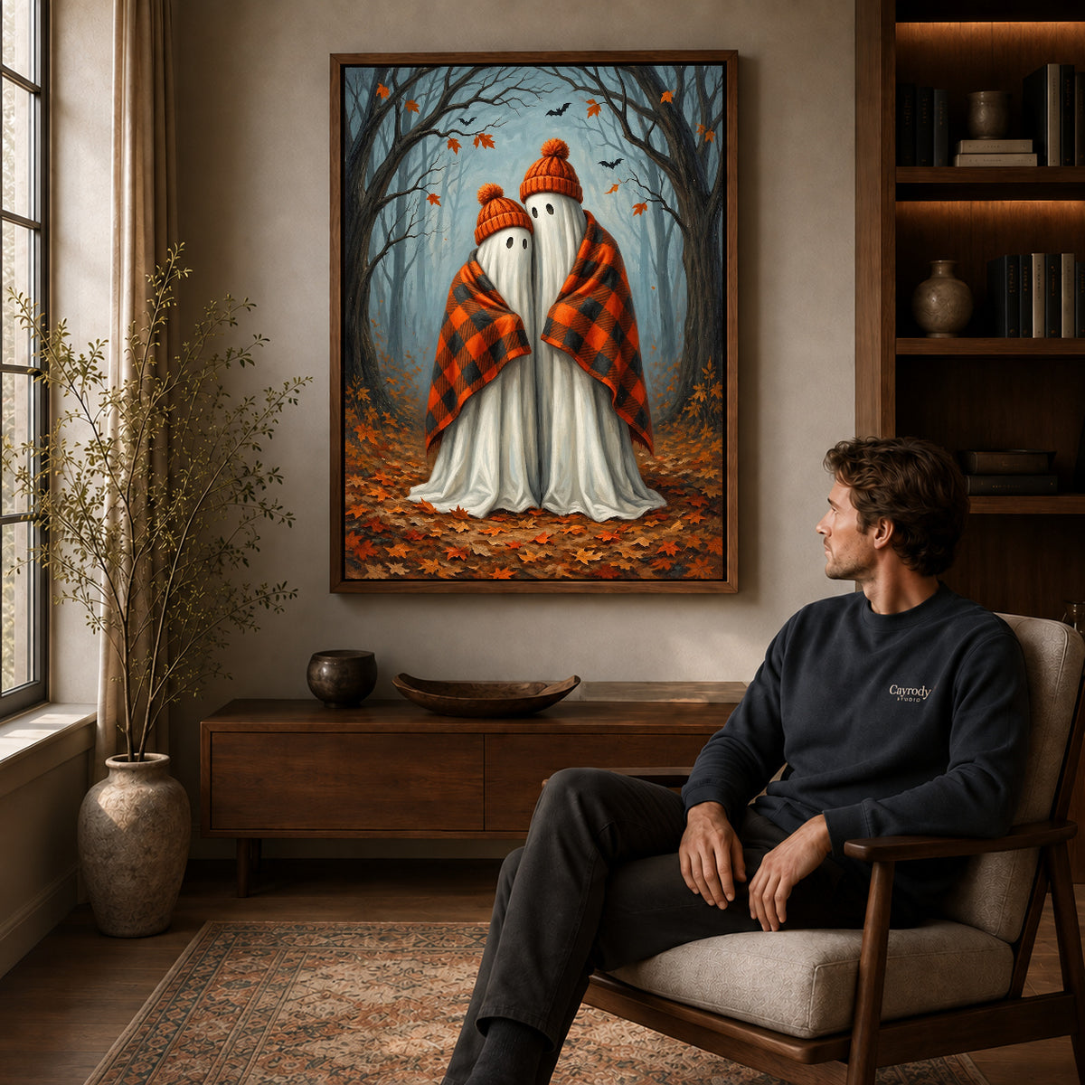 Walnut framed cozy autumn ghosts artwork above a seated man in a wood furnished living room.