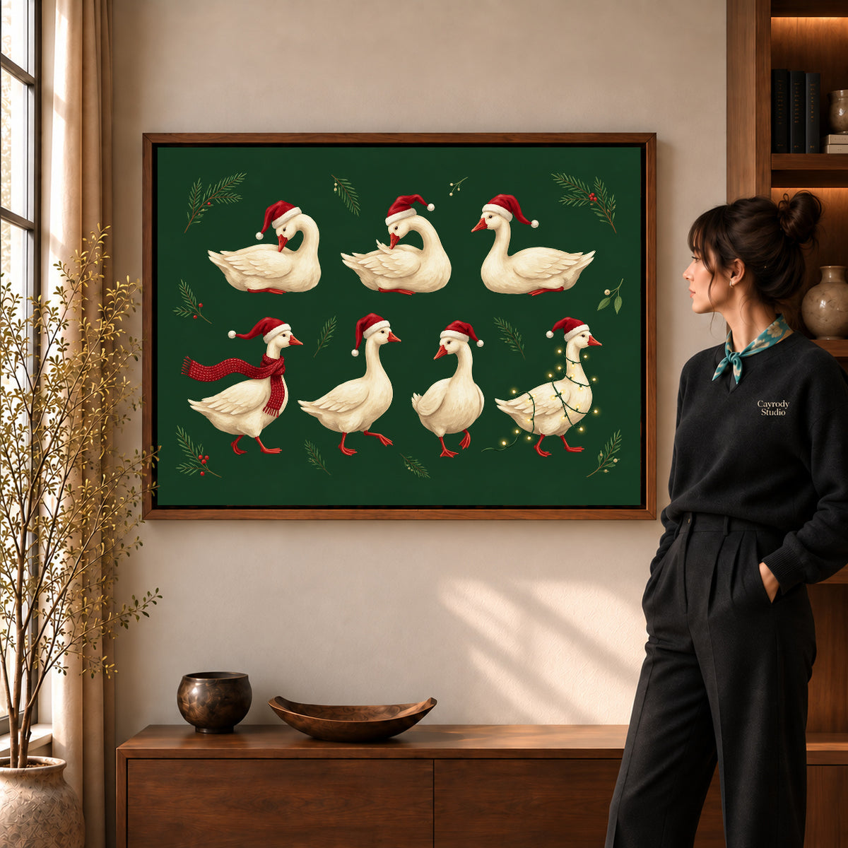 Holiday goose flock canvas art in a walnut frame beside a standing woman in a warm living room.