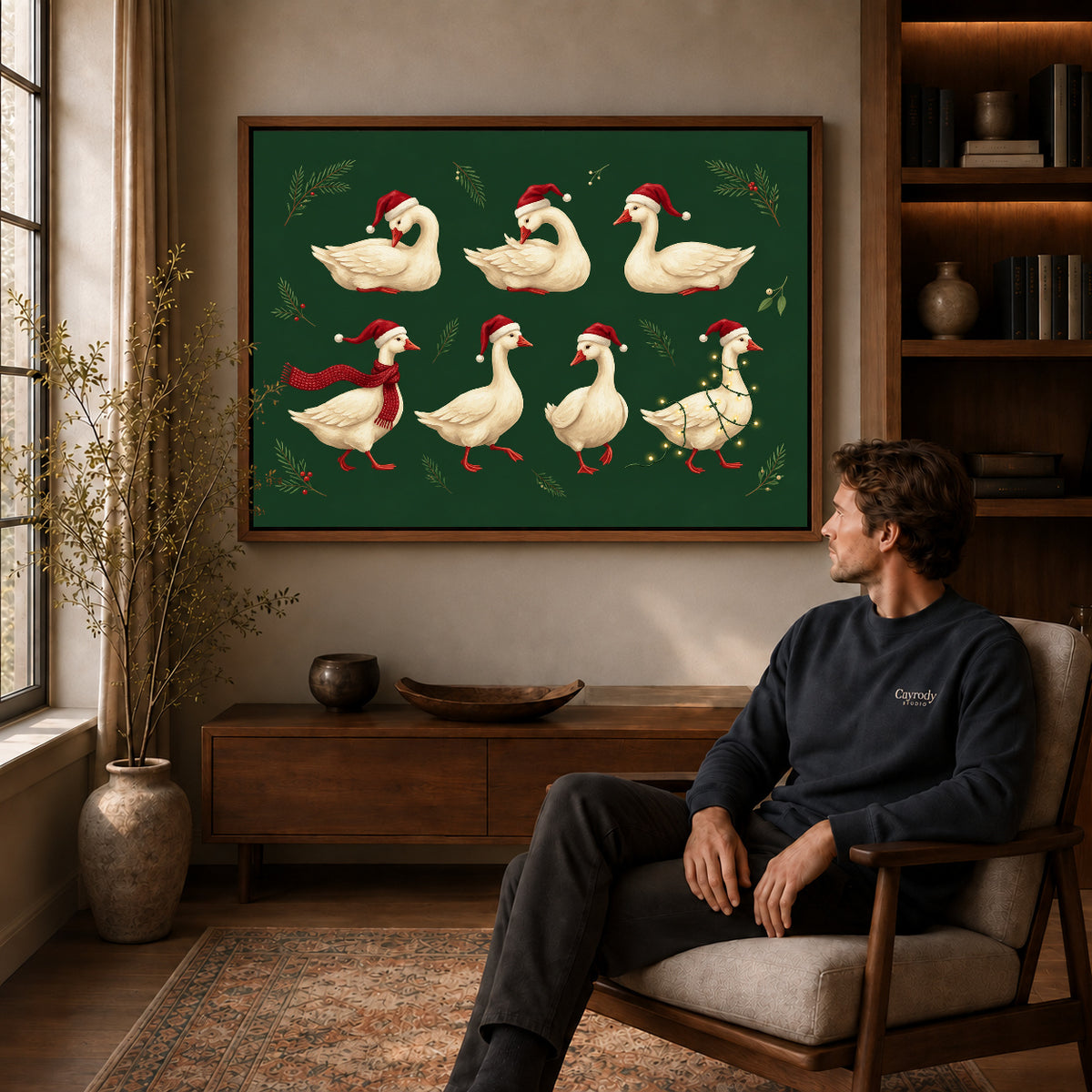 Walnut framed holiday goose flock canvas art displayed above a seated man in a wood furnished room.