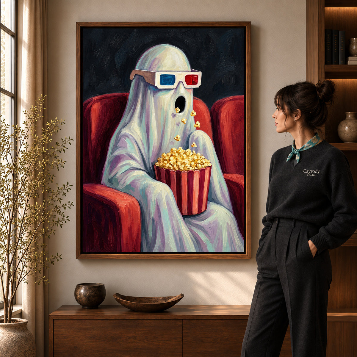 Cinema Ghost Surprise artwork in a walnut frame beside a standing woman in a warm room.