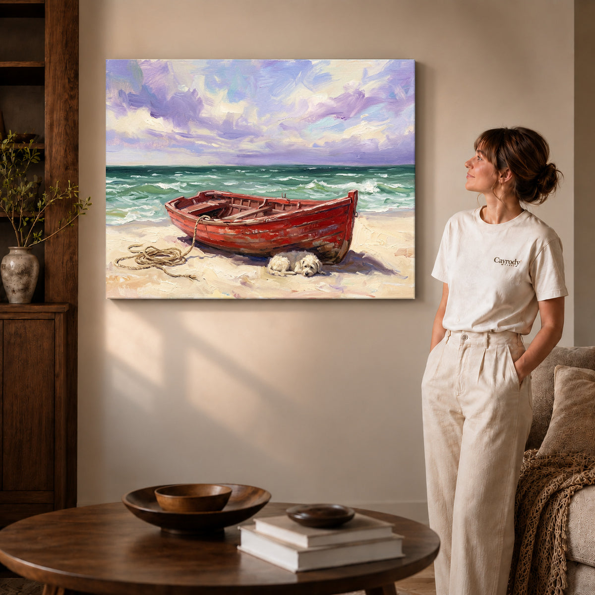 Gallery wrapped red boat beach canvas art with naturally shaded canvas edges beside a woman wearing cream clothing.