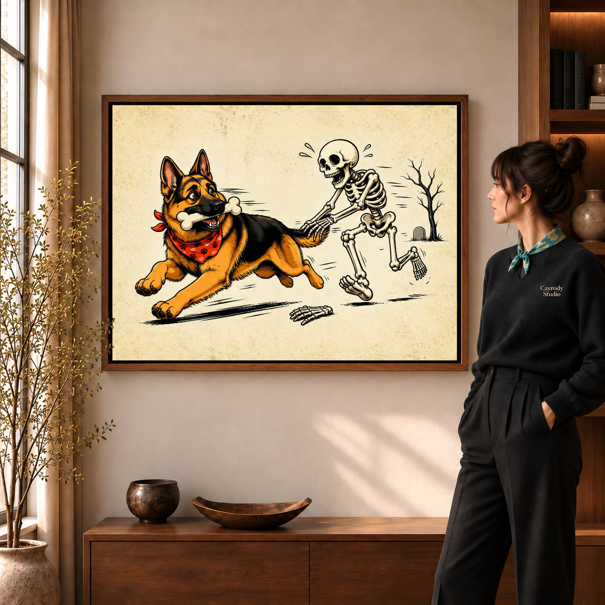 Bone Chase Shepherd artwork in a walnut frame beside a standing woman in a warm room.