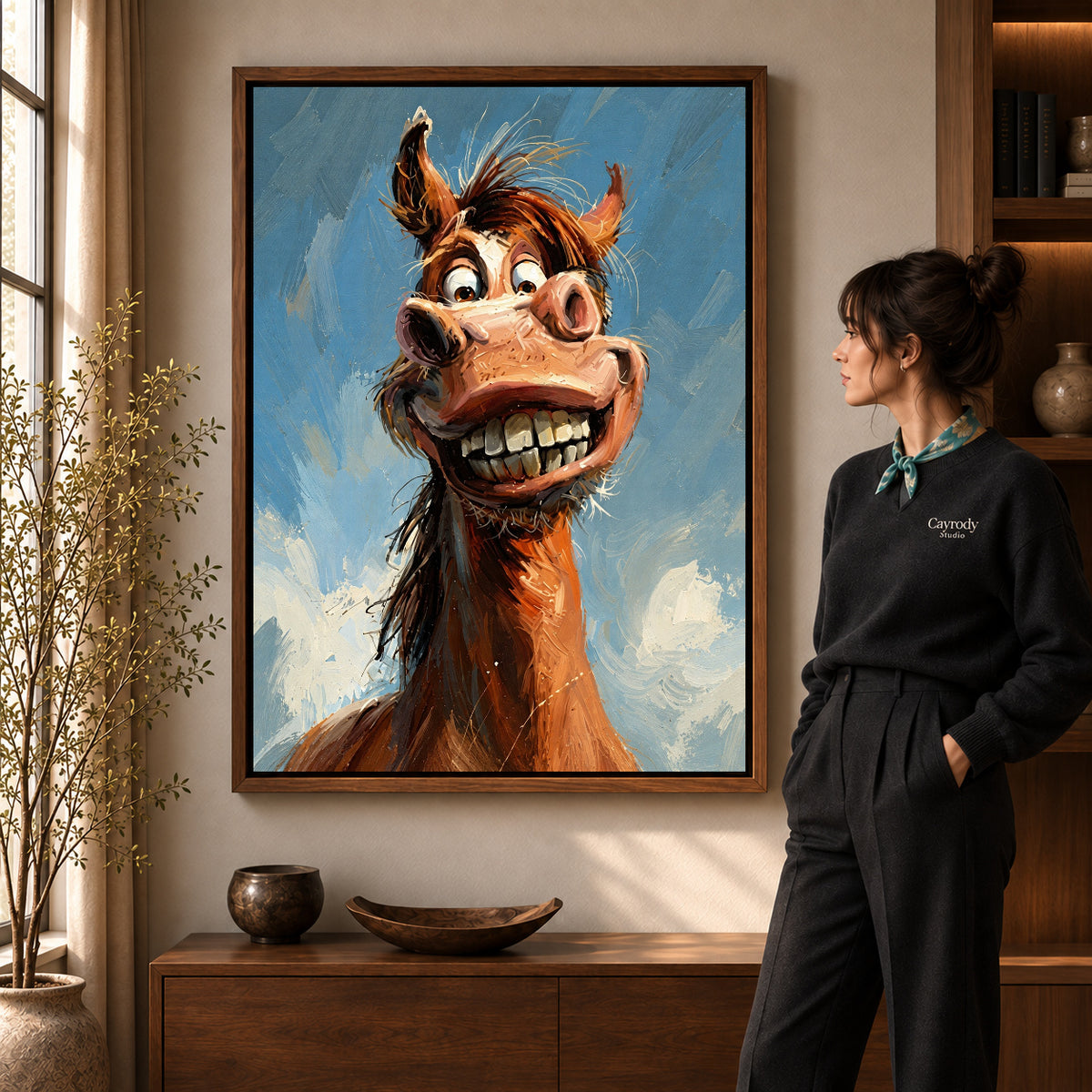 Grinning Horse Portrait artwork in a walnut frame beside a standing woman in a warm room.
