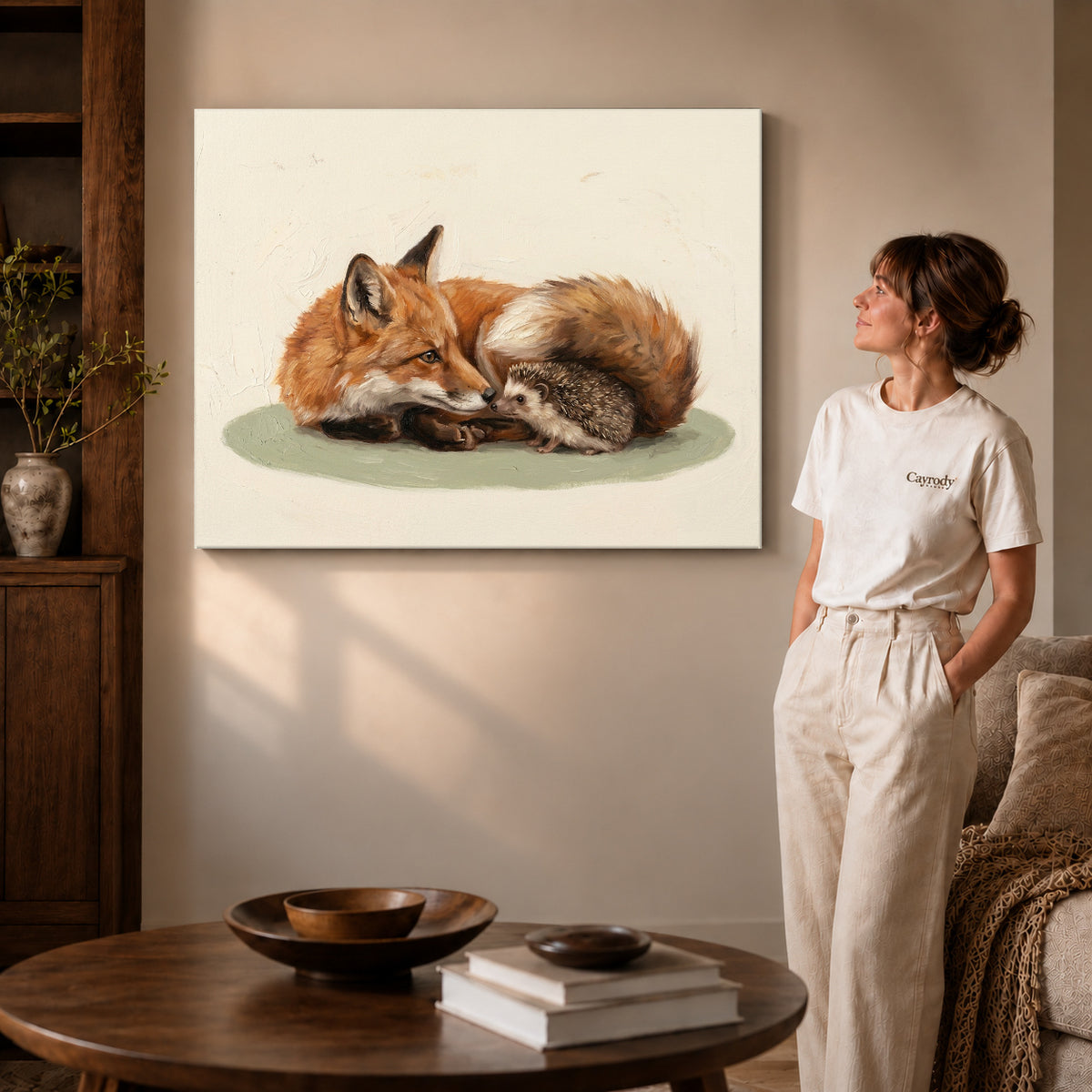 Gallery wrapped fox hedgehog friends canvas art with naturally shaded canvas edges beside a woman wearing cream clothing.