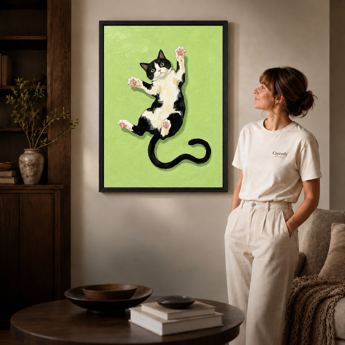 Black framed stretching tuxedo cat canvas art room scene assigned to all six black framed canvas sizes.