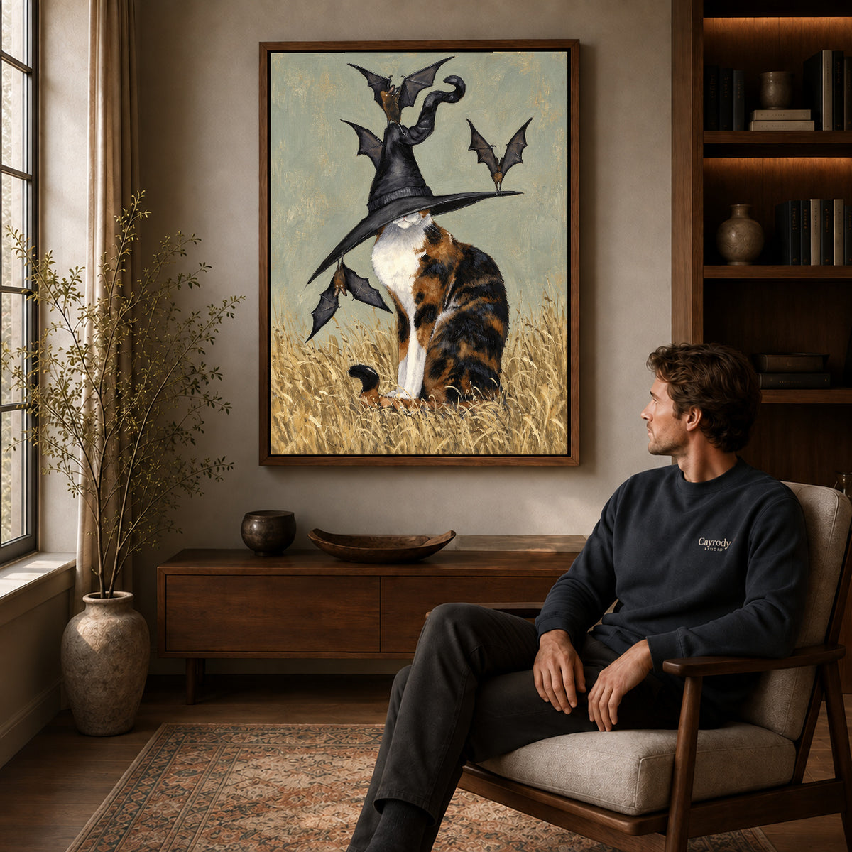 Walnut framed calico witch hat artwork above a seated man in a wood furnished living room.