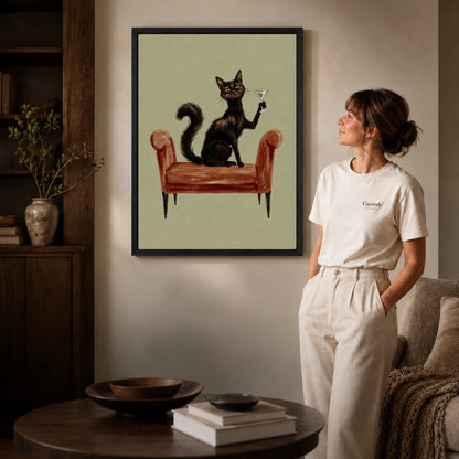 Black framed armchair cocktail cat artwork beside a woman in a warm neutral living room.