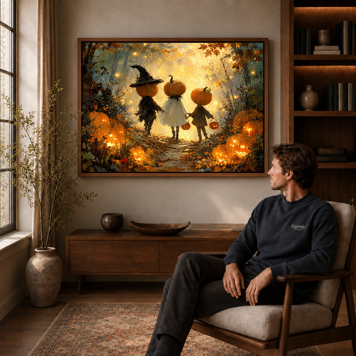 Walnut framed pumpkin forest trio artwork above a seated man in a wood furnished living room.