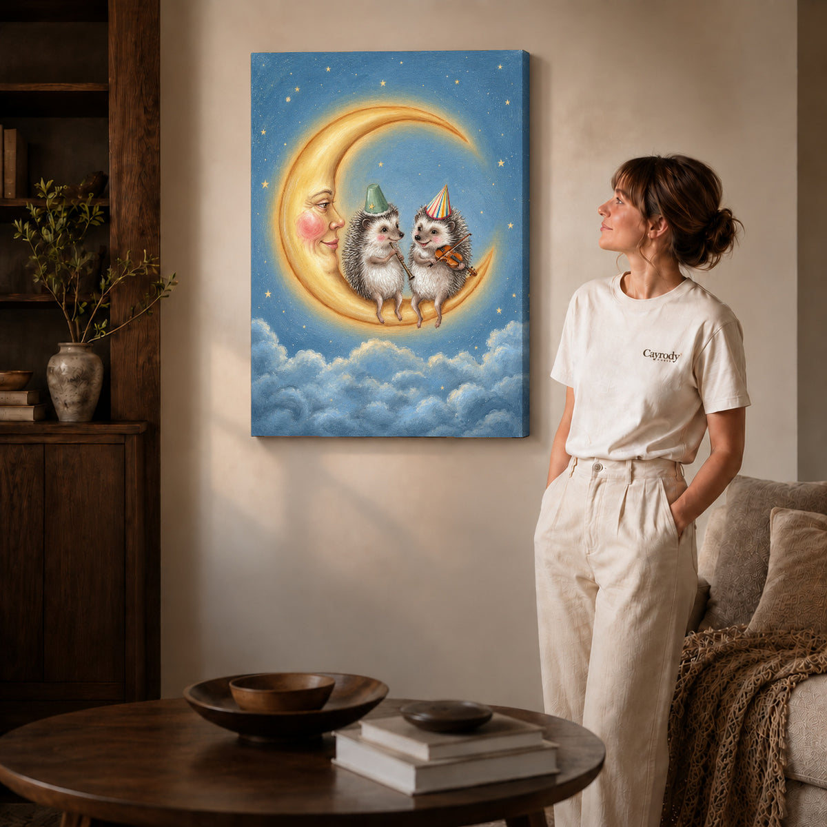 Gallery wrapped moonlit hedgehog musicians artwork with shaded canvas edges beside a woman wearing cream clothing.
