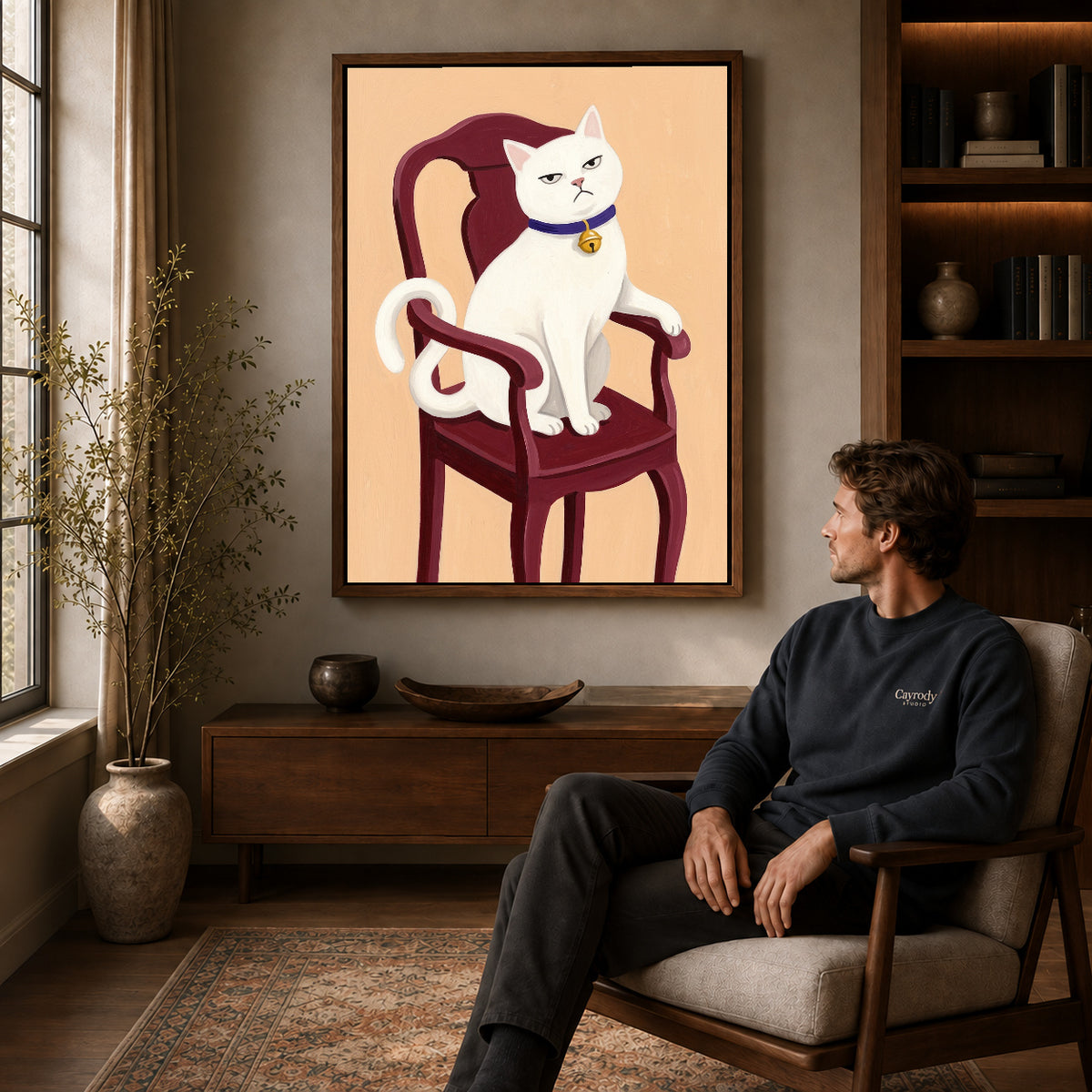 Walnut framed regal white cat artwork above a seated man in a wood furnished living room.