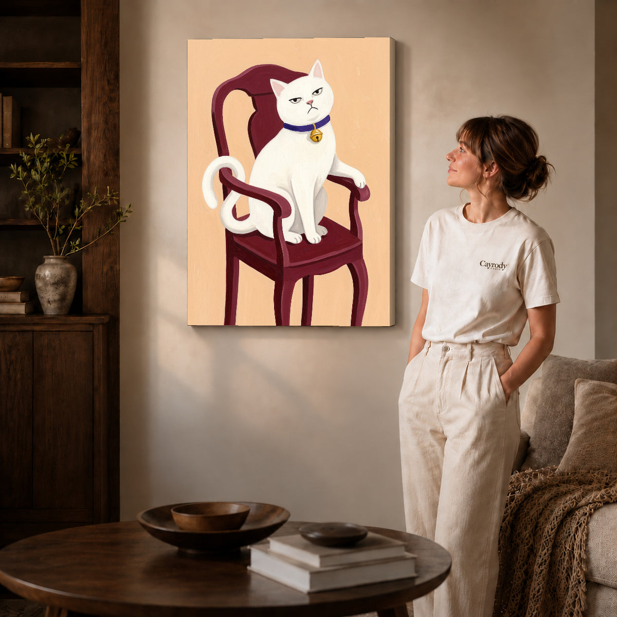 Gallery wrapped regal white cat artwork with shaded canvas edges beside a woman wearing cream clothing.