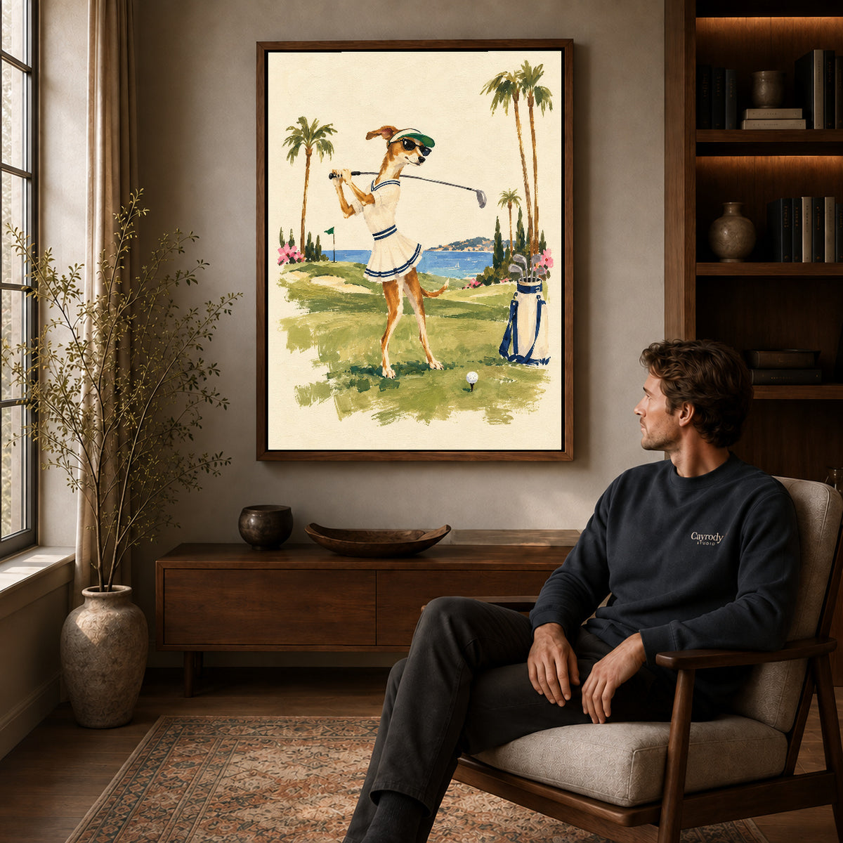 Walnut framed coastal golfing dog artwork above a seated man in a wood furnished living room.