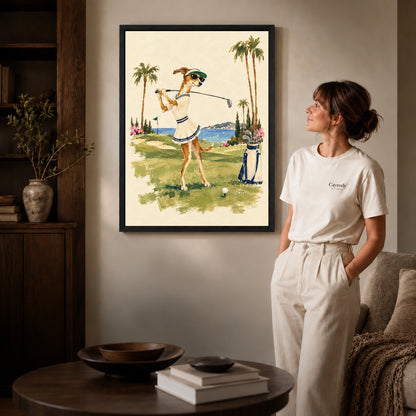 Black framed coastal golfing dog artwork beside a woman in a warm neutral living room.