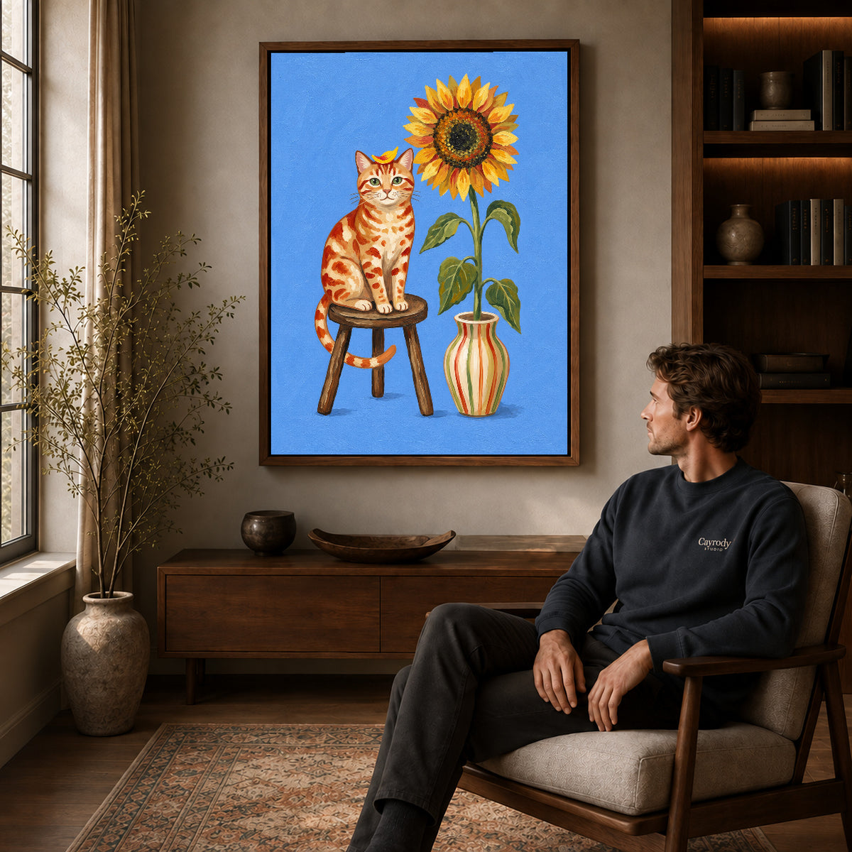 Walnut framed sunflower cat portrait artwork above a seated man in a wood furnished living room.
