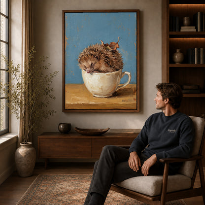 Walnut framed sleepy teacup hedgehog artwork above a seated man in a wood furnished living room.