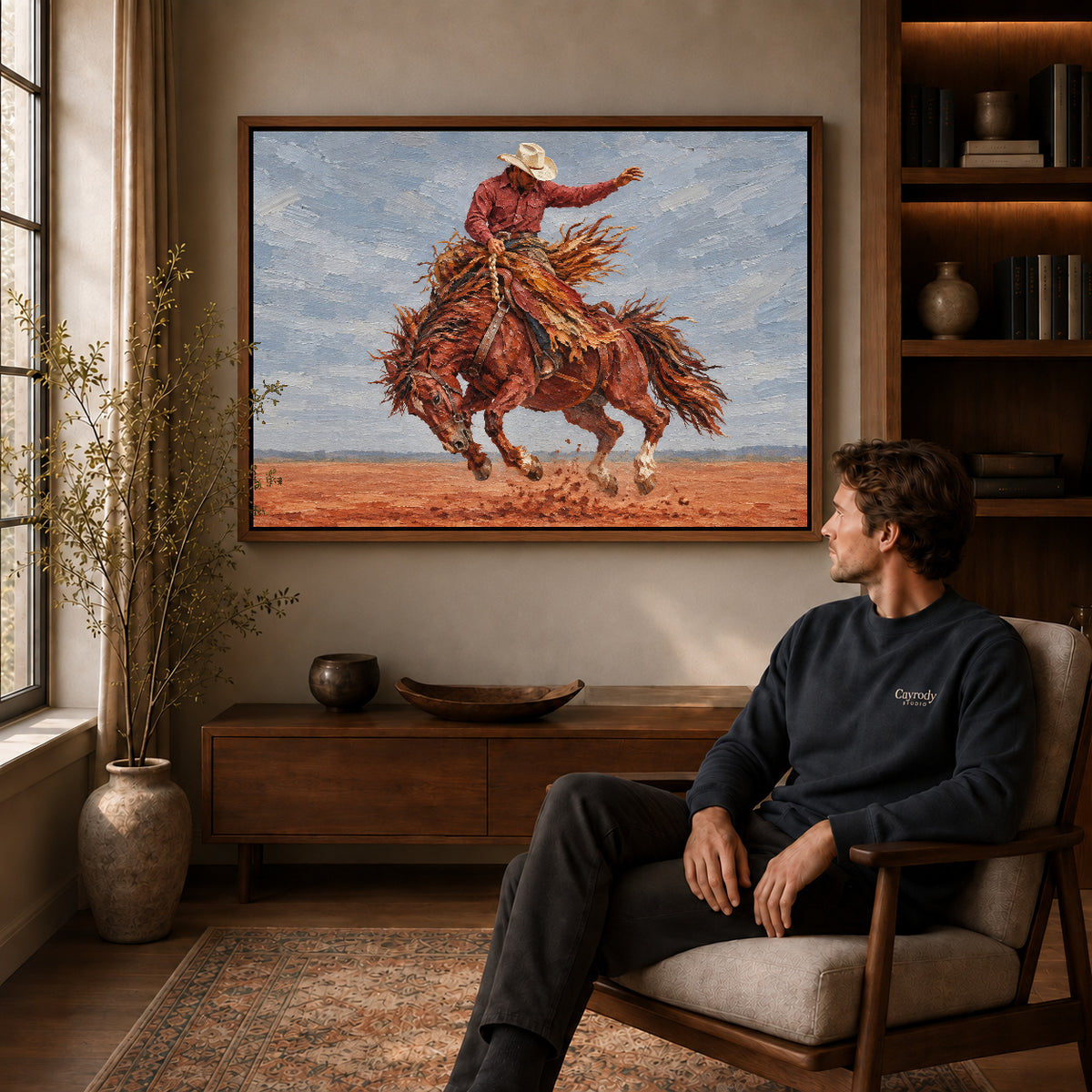 Walnut framed bucking horse rider artwork above a seated man in a wood furnished living room.