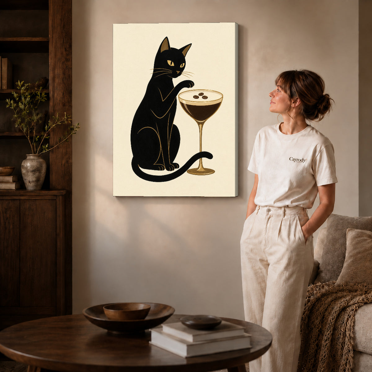 Gallery wrapped espresso martini cat artwork with shaded canvas edges beside a woman wearing cream clothing.