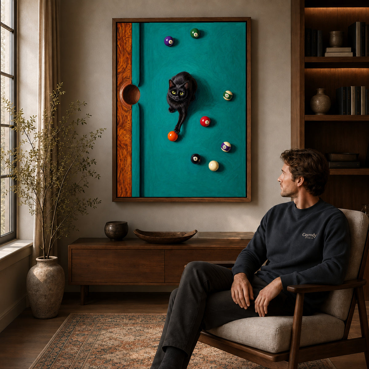 Walnut framed playful billiard cat artwork above a seated man in a wood furnished living room.