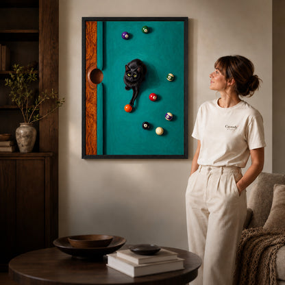 Black framed playful billiard cat artwork beside a woman in a warm neutral living room.