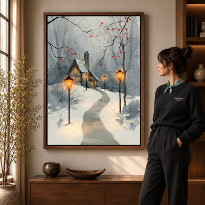 Snowy Cottage Lights artwork in a walnut frame beside a standing woman in a warm room.