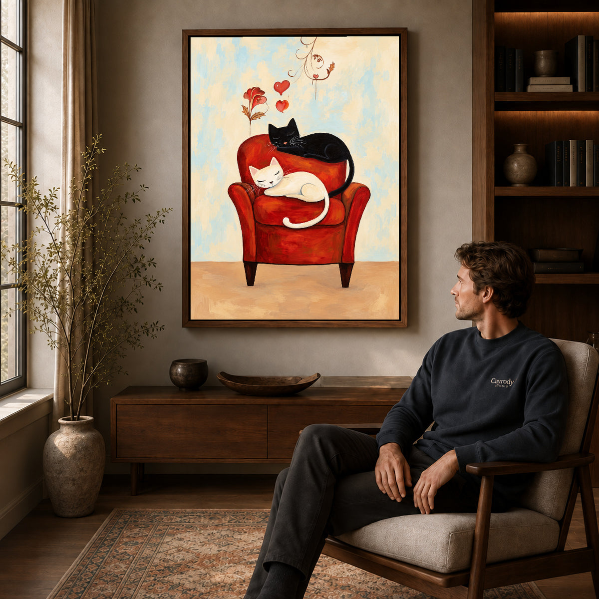 Walnut framed sleeping armchair cats artwork above a seated man in a wood furnished living room.