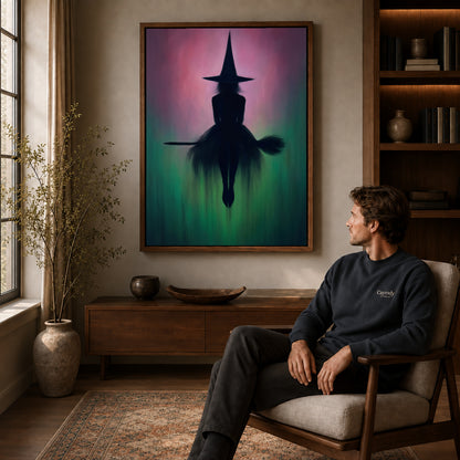 Walnut framed moody witch silhouette artwork above a seated man in a wood furnished living room.