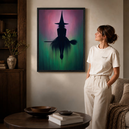 Black framed moody witch silhouette artwork beside a woman in a warm neutral living room.