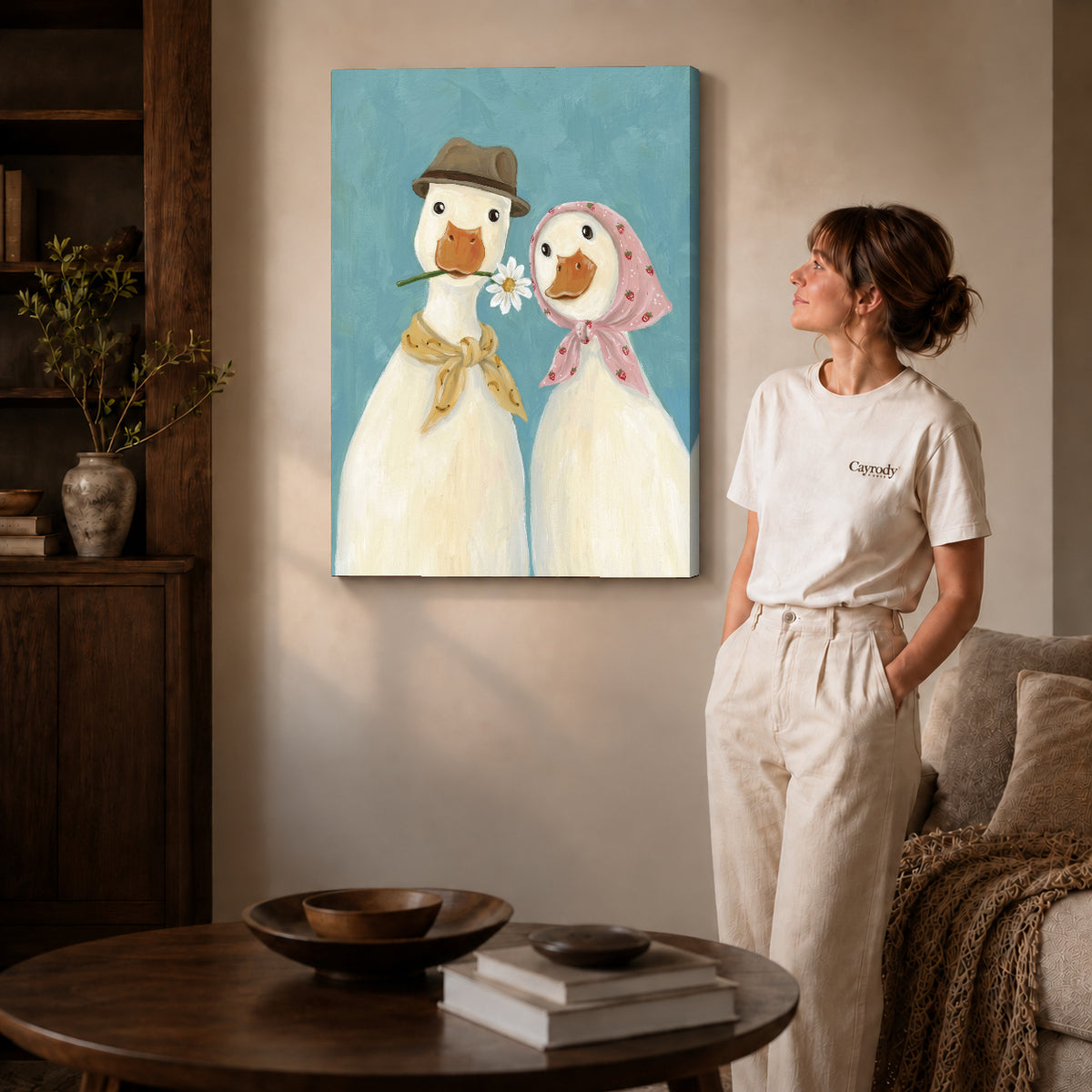 Gallery wrapped daisy duck couple artwork with shaded canvas edges beside a woman wearing cream clothing.